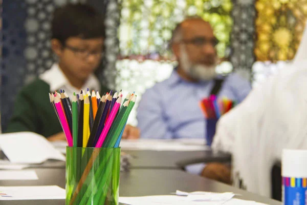 Coloured pencils on a table during an art workshop