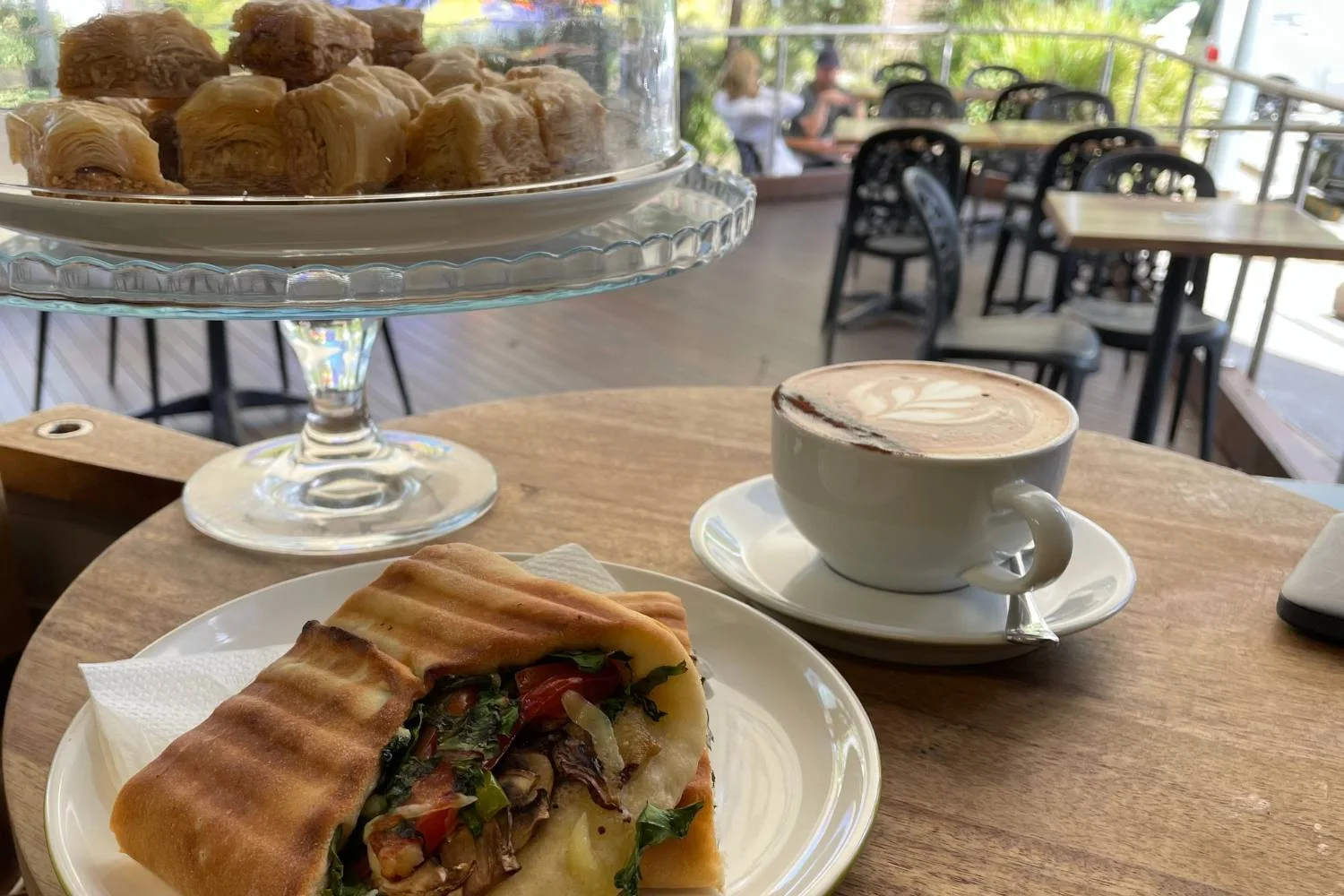 A toasted wrap and coffee on the cafe terrace