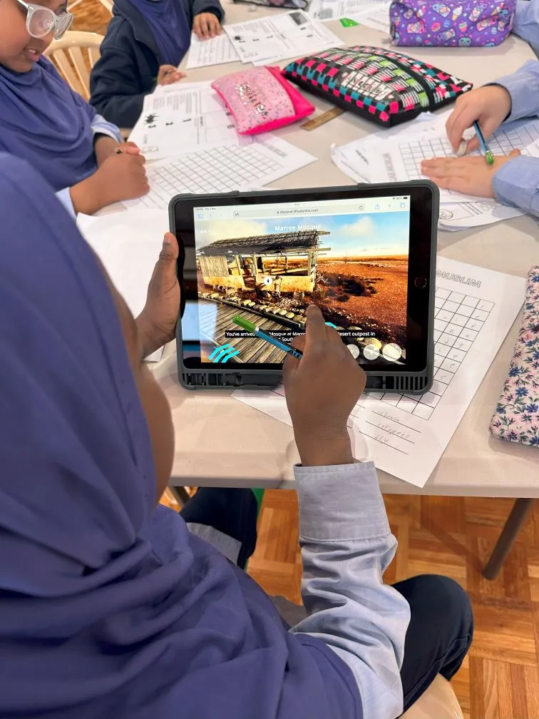 A student using a tablet during an activity