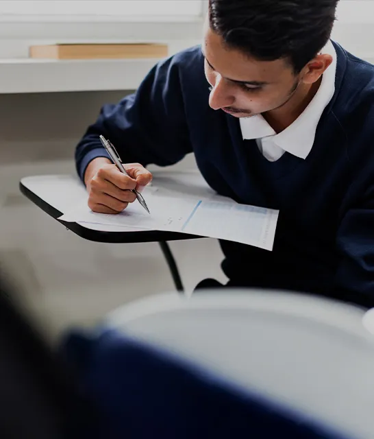 Student writing during a museum program